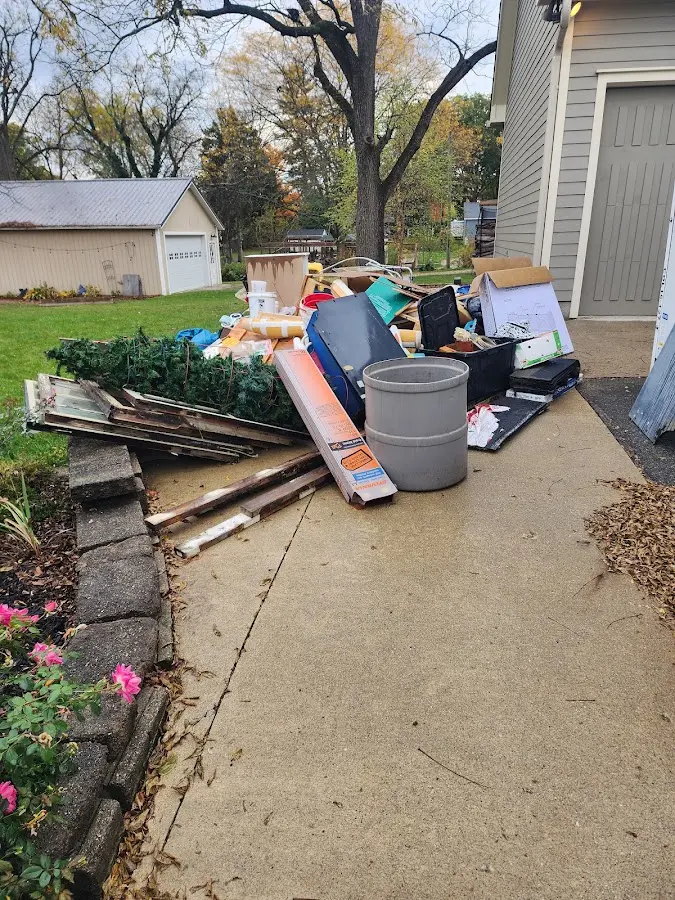 Dumpster being loaded with debris for 12 Yard Dumpster Rental in Grenada